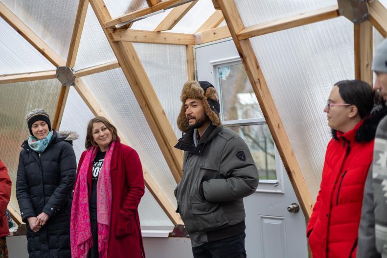 A group of peoples standing inside one of the domes.