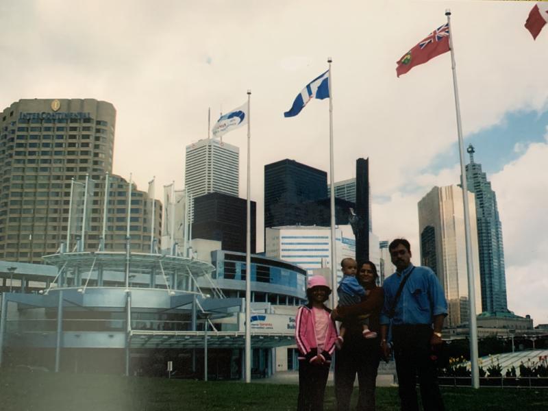 9-year-old Aarohi Pathak, with her mother, father, and baby sibling, in front of Toronto City Hall.