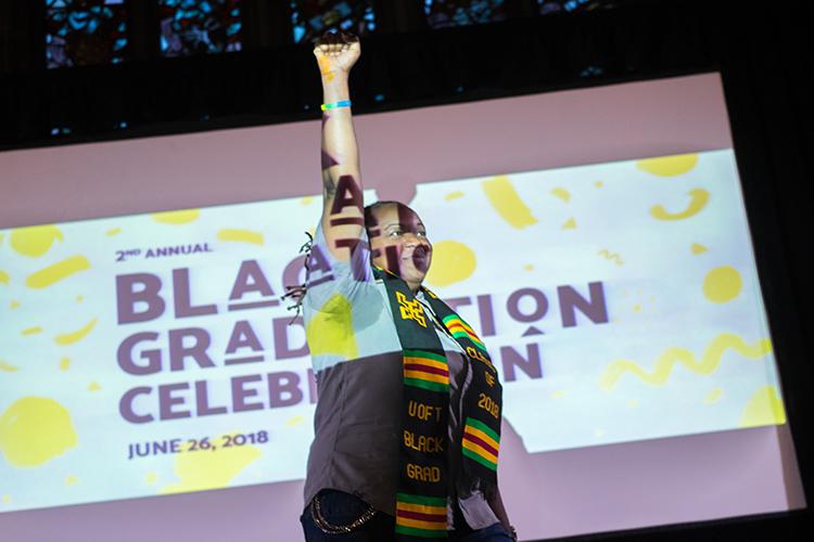 Jordyn Samuels celebrates after being called to the stage to accept a U of T Black Grad Class of 2018 scarf.