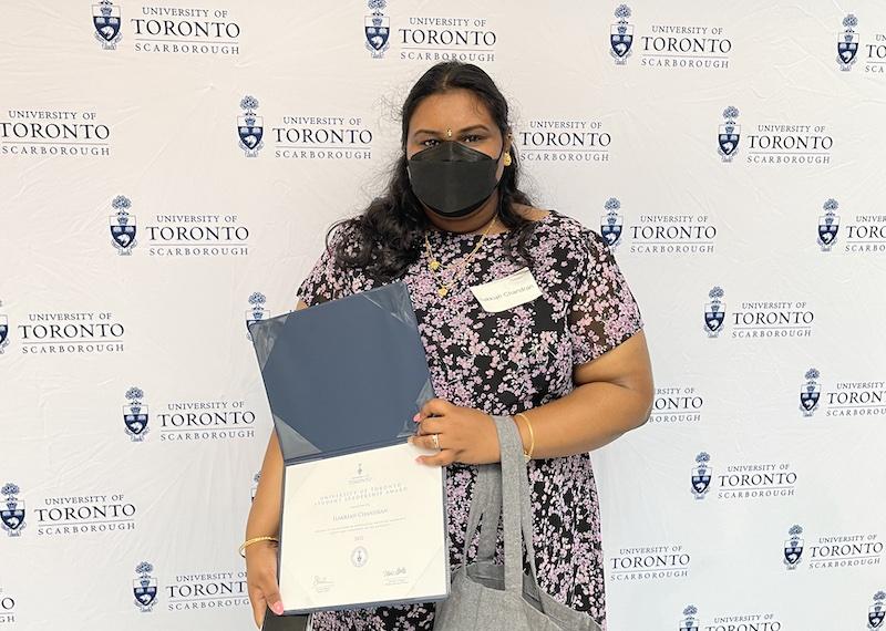 Ilakkiah Chandran holds her framed University of Toronto Student Leadership Award.