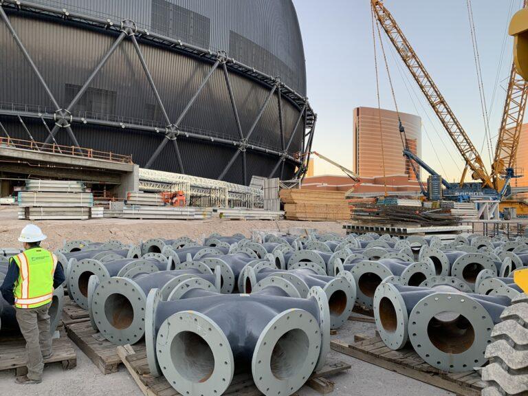 Enormous steel nodes, each with six entry points, sit on a construction site.