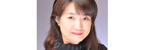 A portrait of Minako Uchino smiling.