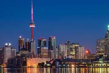 Photo of the Toronto skyline at night, including the CN Tower