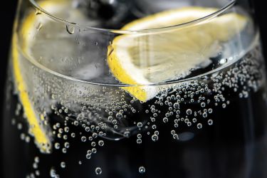 Glass of fizzy water with lemon slices
