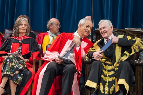 Geoffrey Matus, who received an honorary doctor of laws, honoris causa, on Wednesday, speaks to U of T Chancellor Michael Wilson at the convocation ceremony (photo by Steve Frost) 
