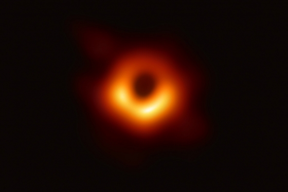 The black hole looks like a dark circle surrounded by a glowing donut of light, brighter on one side.  (photo courtesy of U.S. National Science Foundation) 