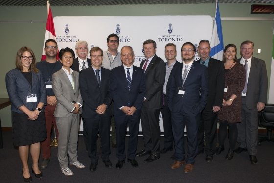 U of T President Meric Gertler poses with city manager Peter Wallace and Mayor John Tory, city councillors and city-focused faculty at the MOU signing event at City Hall (photo by Laura Pedersen) 