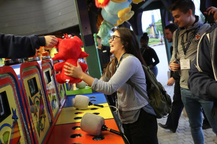 Young women wins a stuffed animal at a carnival game