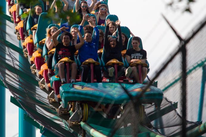 UofT alumni riding a roller coaster