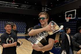 Matthew Kieffer holding a large sports trophy