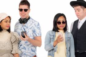 Two people dressed in modern and pioneer era clothing.