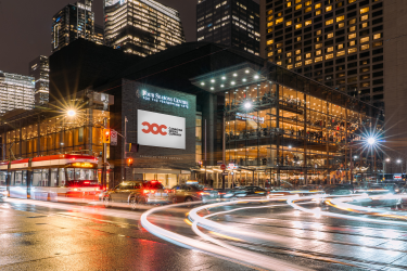 Four Seasons Centre building with street traffic lights glowing