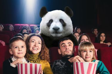 A family watching a movie with a panda in a theatre
