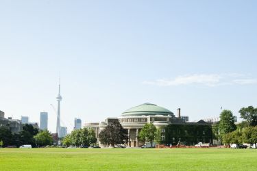 Panoroma photo of Front Campus and Convocation Hall in summer, with CN Tower in the background.