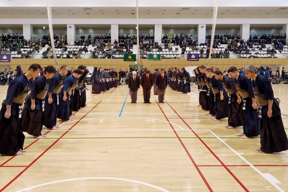 U of T alumni bow respectfully to each other before a kendo event.