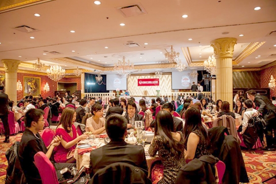 Group of Chinese alumni sit at a banquet table at an elegant dinner event.