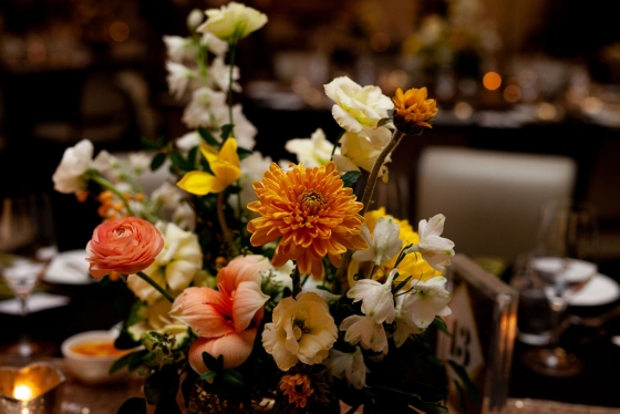 Floral arrangement of orange and white flowers.