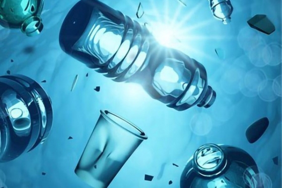 Underwater picture showing plastic bottles in water with sun in background.