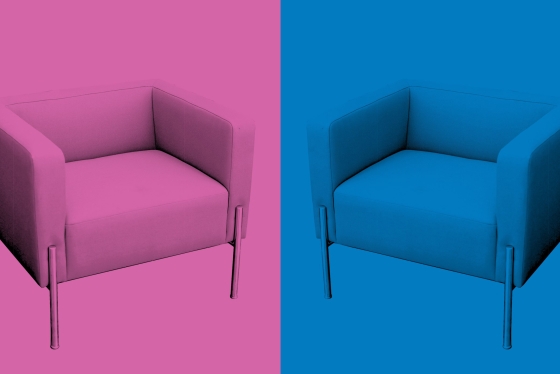Two chairs, pink and blue, arranged toward each other.