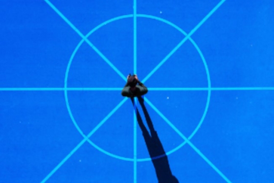 Person standing on target with long shadow