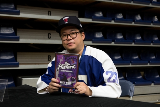 Alex Wong holding his book