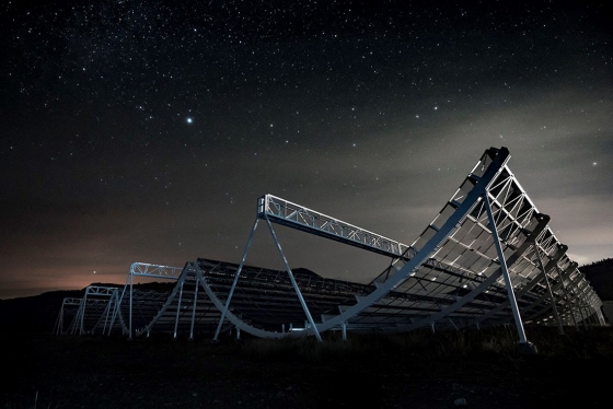 The CHIME radio telescope looks like giant cylinders made of metal scaffolding, cut in half, and lying on their sides.
