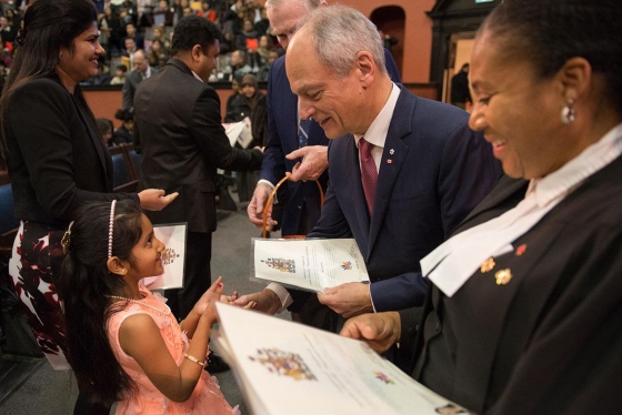 U of T President Meric Gertler greets a young, new Canadian at a citizenship ceremony in Convocation Hall on Saturday (all photos by Laura Pedersen) 