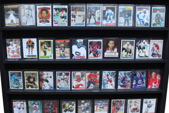A display of laminated hockey cards on a bookcase.