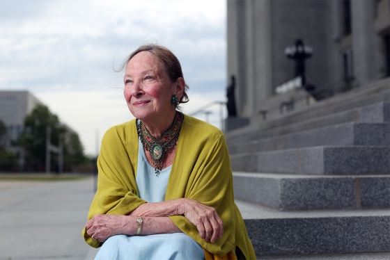 Rosalie Abella smiles, sitting on the steps of the Canadian supreme court.