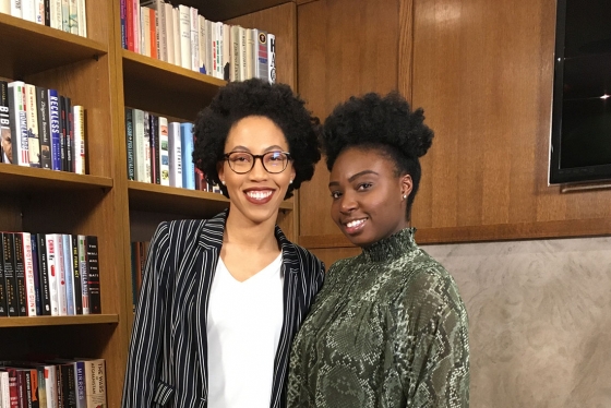 Anna-Kay Russell and Eunice Kays smile together in a library.