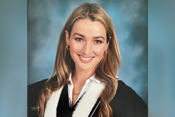 Annie Clark smiles in a formal graduation portrait.