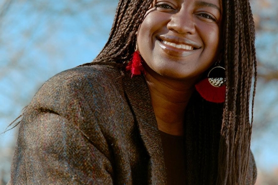 Portrait image of Tea Mutonji smiling.