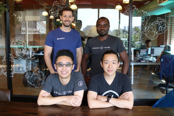 Four diverse members of the startup BenchSci pose in their modern office.