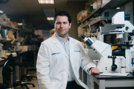 Brian in a lab wearing a white coat