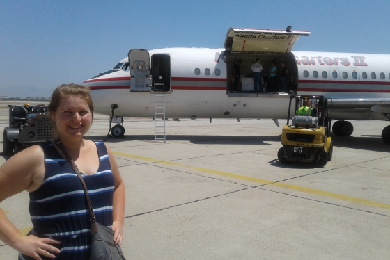 Camilla Urbaniak standing in front of the NASA plane that holds her research samples.