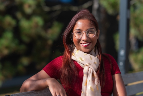 Portrait of Rashmi de Silva Wijeyeratne sitting on a bench