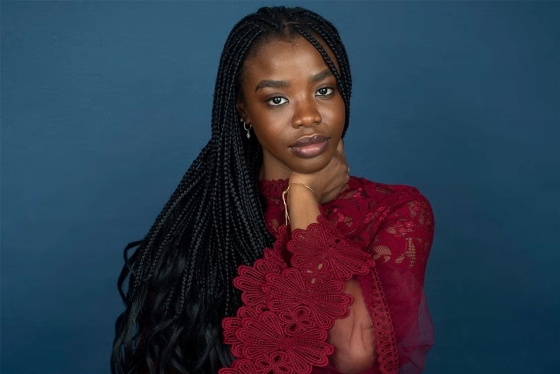 Portrait of Kudakwashe Rutendo in a burgundy lace dress