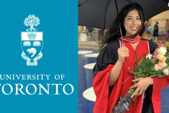 Sanamtha Yammine smiles, wearing academic robes and holding flowers and an umbrella.