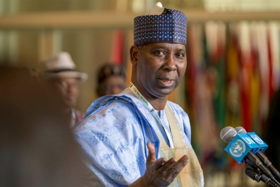 Tijjani Muhammad-Bande, wearing traditional Nigerian clothing, speaks before a United Nations microphone.