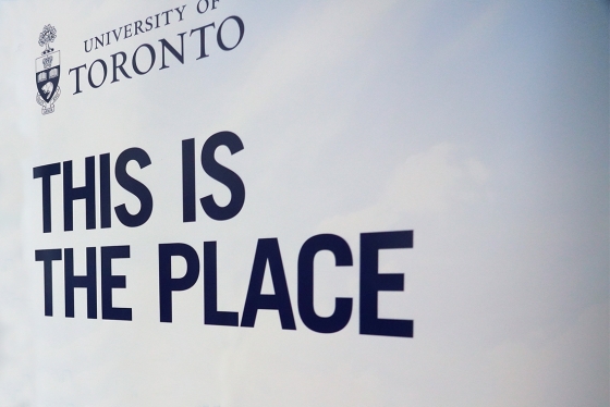 A sign shows the words This is the Place under the University of Toronto logo.