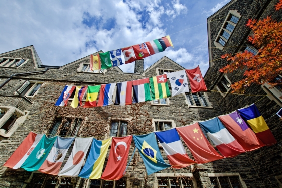 Rows of flags from dozens of countries hang from cords in the quadrangle of Victoria College residence.