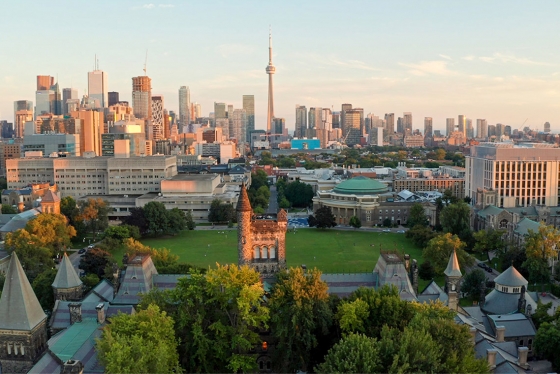 In an aerial view, the tower of University College glows in the sunset above downtown Toronto.