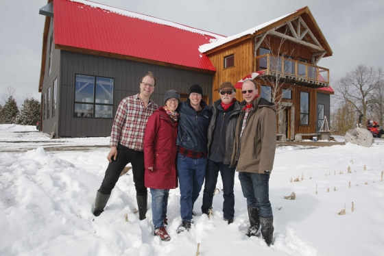The Tomory family in front of their red-roofed barn at Pefferlaw Creek Farms