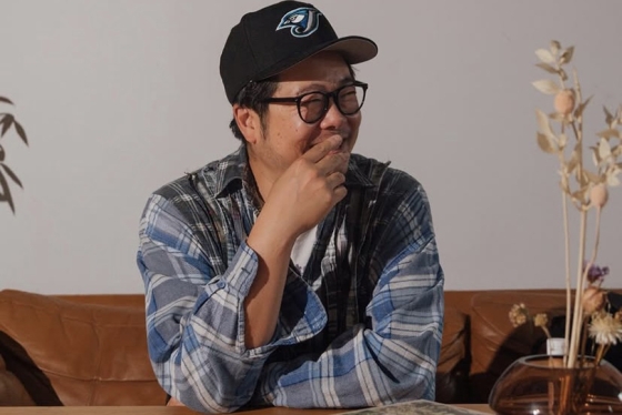 Alex Wong wearing a baseball cap