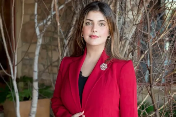 A portrait of a woman wearing a red blazer