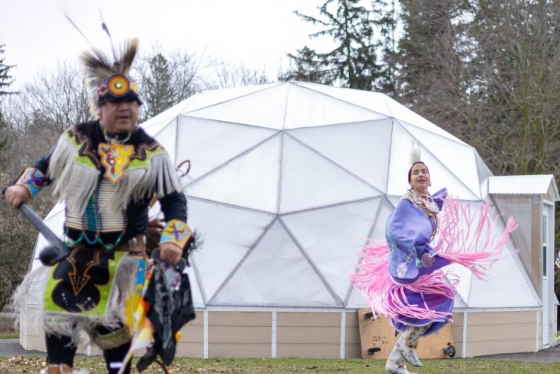 Indigenous dancers performing in front of a white dome