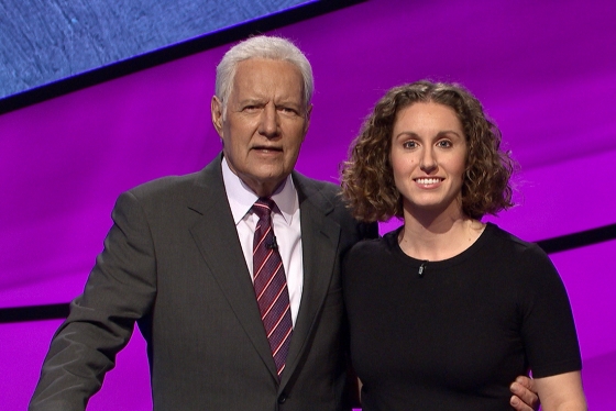 Brooke Mackenzie smiles while posing for a picture with Alex Trebek.