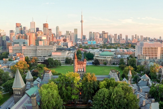 In an aerial shot, Front Campus and University College glow in sunset light. Downtown Toronto stretches behind them.