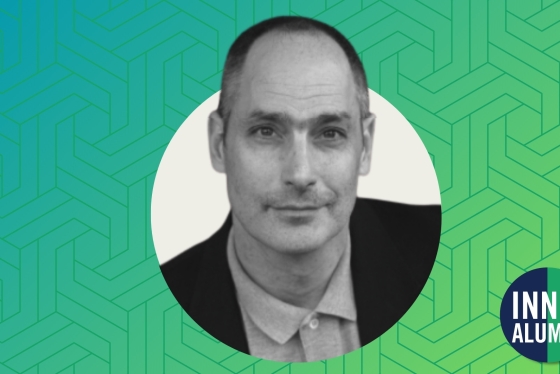 Black and white headshot of Professor Jeffrey Ian Ross displayed on a textured blue and green gradient background.