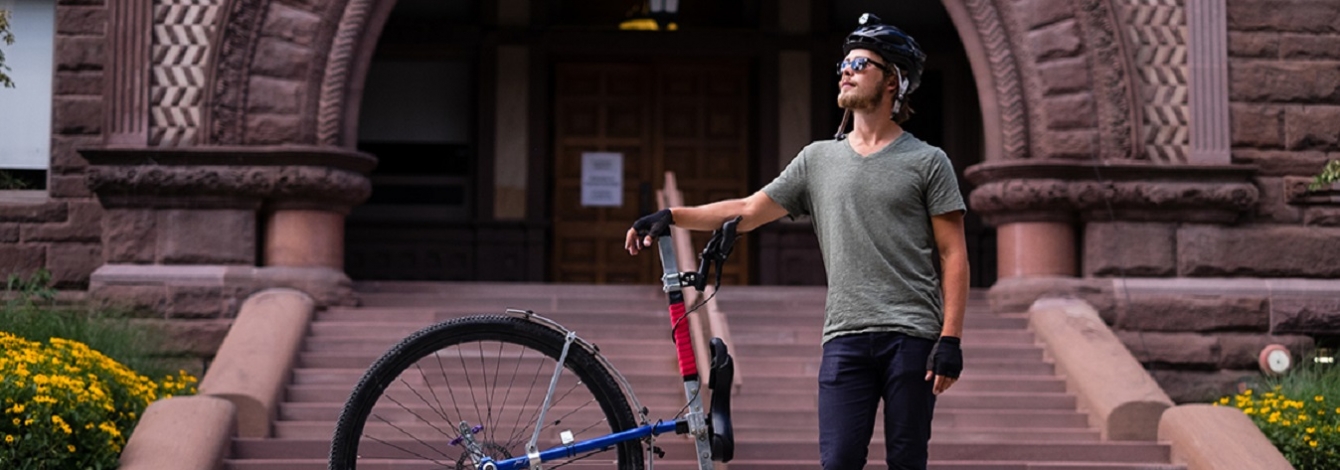 Taylor Stark, a U of T alumnus who is returning for a master's degree in classics, rode his unicycle "Caroline" from Vancouver to Toronto (photo by Geoffrey Vendeville)